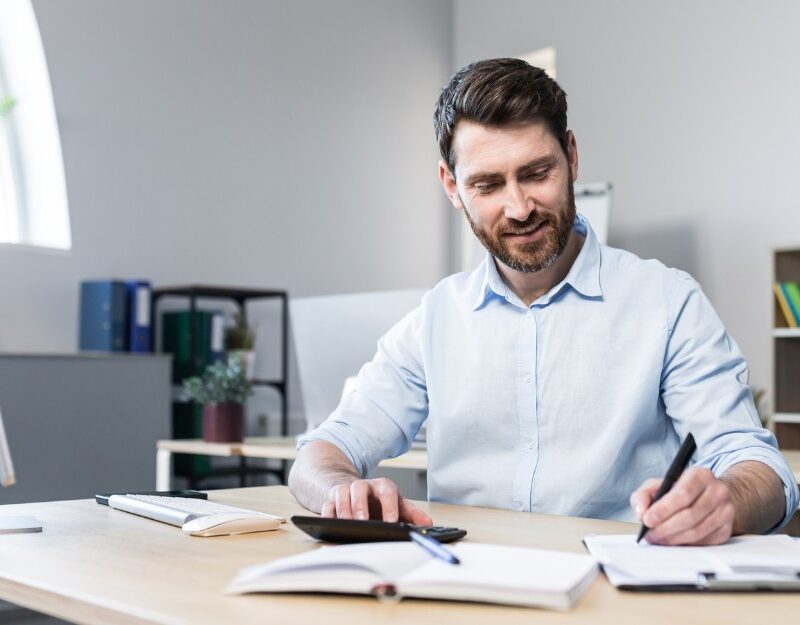 White/caucasian man calculating his business owner salary