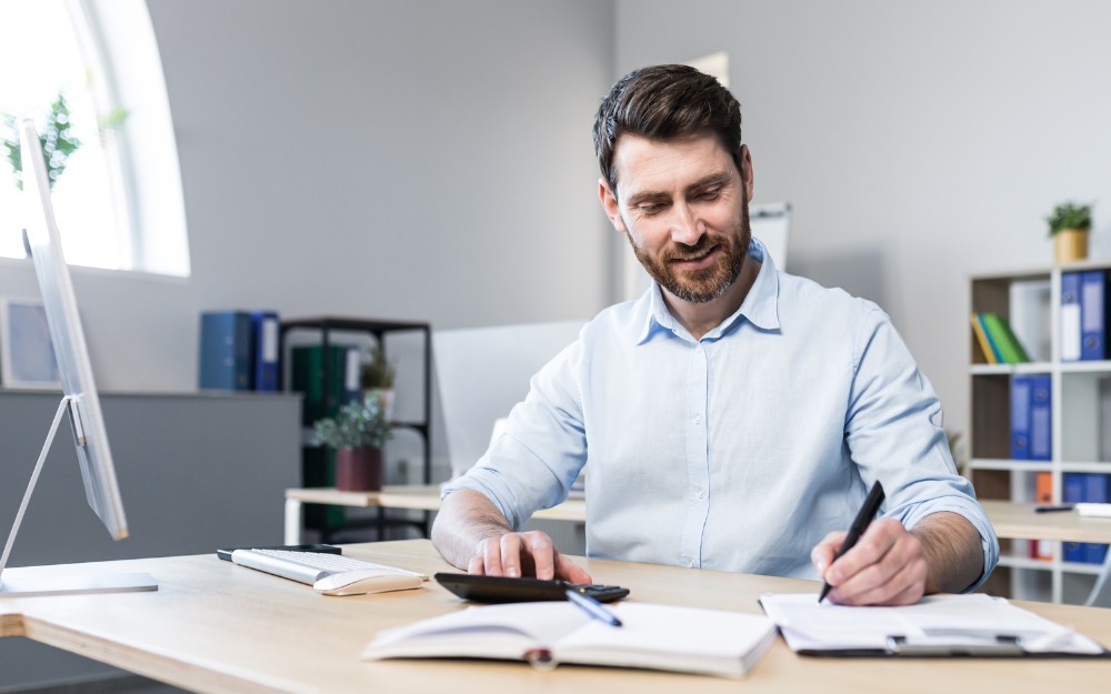 White/caucasian man calculating his business owner salary