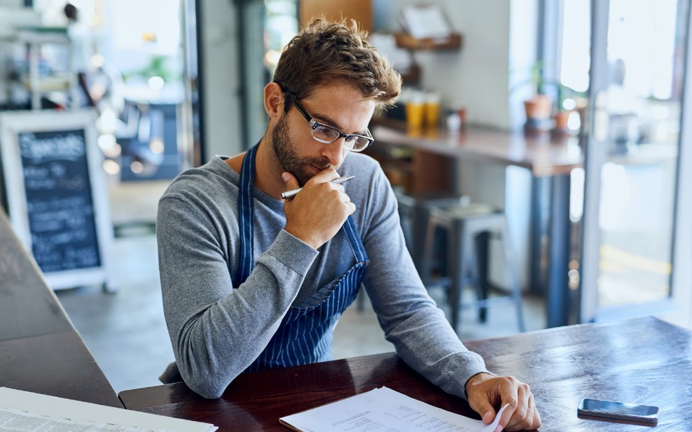 Small business owner thinking about cash flow problems