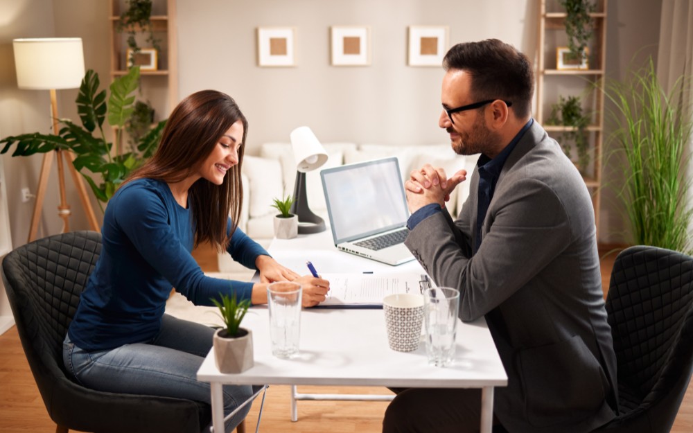 Woman signing a document after securing a small business loan