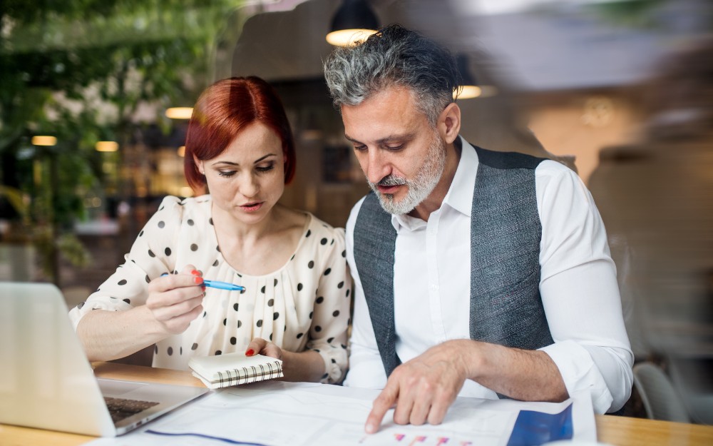 Two people learning the basics of accounting and double-entry bookkeeping