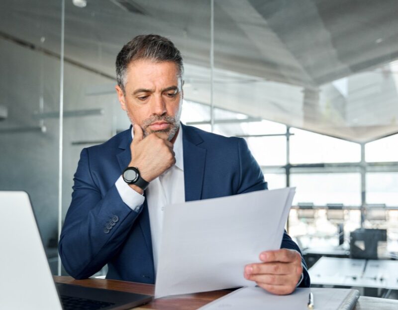 Company director reading an ATO Directors Penalty Notice in his office