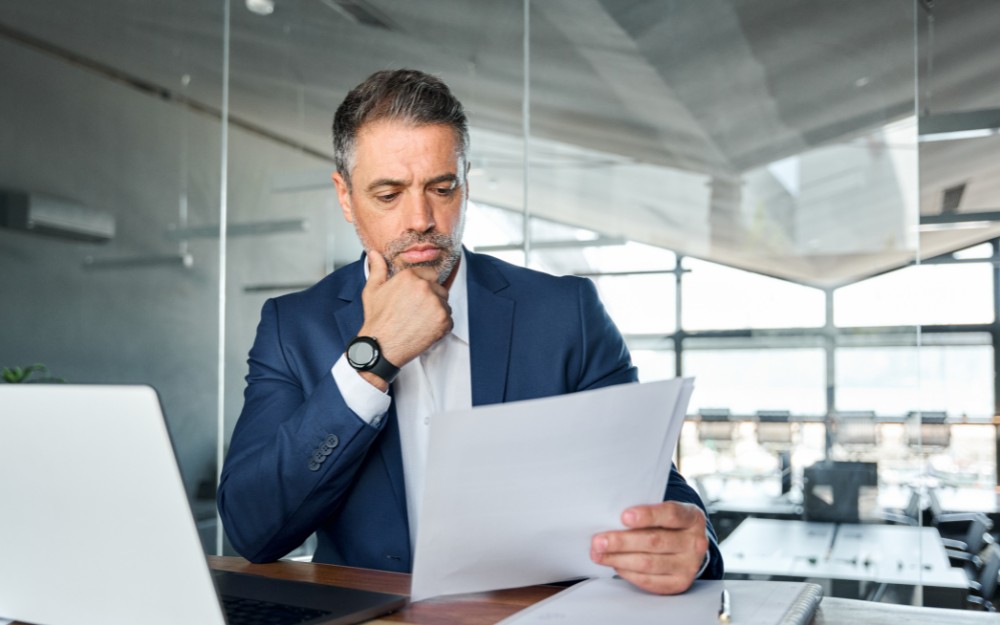 Company director reading an ATO Directors Penalty Notice in his office