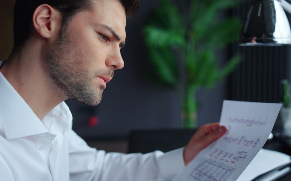 Businessman holding a report while working on payg instalments