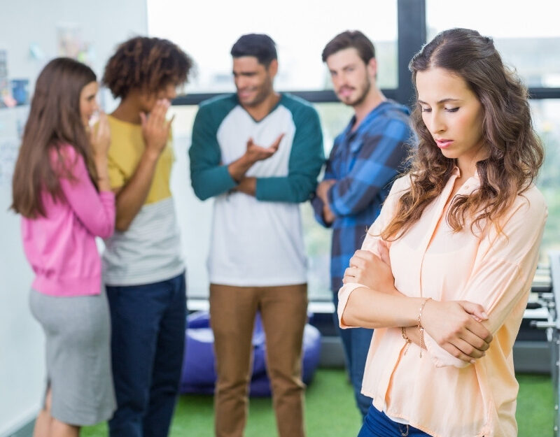 Toxic team members gossiping about a colleague